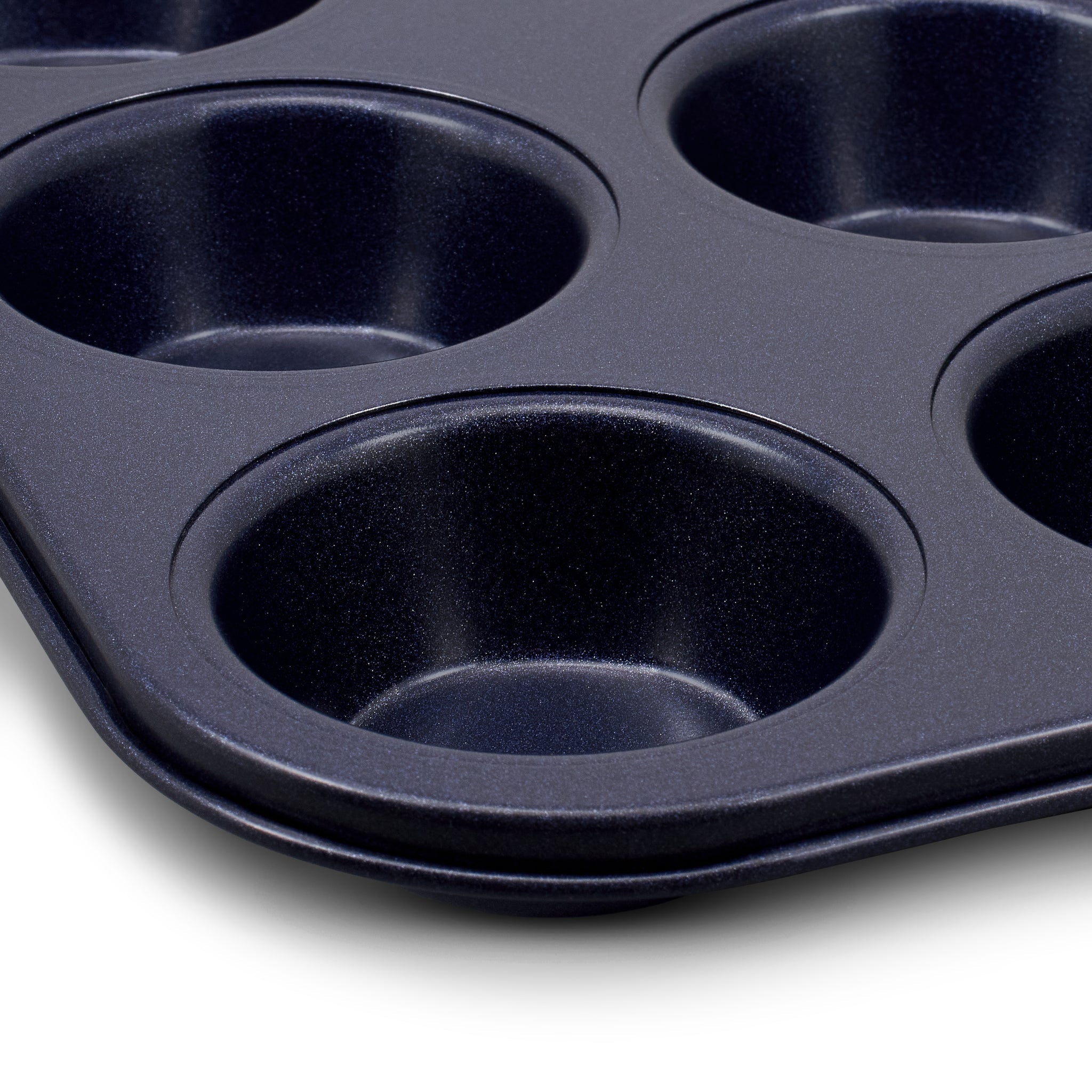 Close-up of a black, non-stick muffin or cupcake baking tray with several round cups, set against a white background.