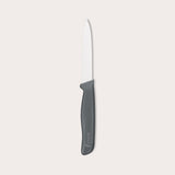 The Zyliss Paring Knife Serrated 10cm / 4, featuring a black ergonomic handle and eco-friendly material, is displayed against a plain white background. 