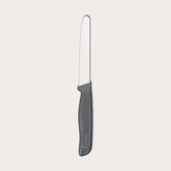 The Zyliss Tomato Knife Serrated 11cm / 4½ features a silver serrated blade and an eco-friendly handle, shown against a plain white background. 