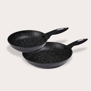 Two Zyliss Ultimate Non-Stick Frying Pans, each with a black handle and Swiss non-stick coating with white speckles, are stacked on a light background. The pans are different sizes. #2Pc_Set