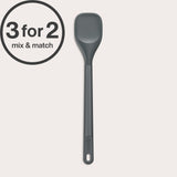 The Zyliss Spoontula, a grey heat-resistant silicone spoon with a long handle and durable head, rests on a light background. A circular label in the corner reads 3 for 2 mix & match.#Medium