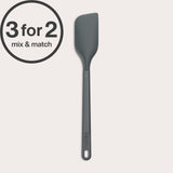 A dark grey Zyliss Spatula with a heat-resistant silicone head and handle hole is shown on a light background. A circular label in the top left corner reads 3 for 2 mix & match.#Medium