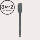 A long-handled Zyliss Spatula in dark gray with a heat-resistant silicone head is displayed on a light background. A 3 for 2 mix & match circular label appears in the top left corner.#Small